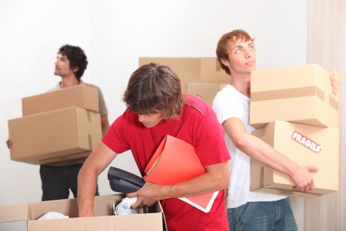 A moving team carefully packing furniture and boxes for removals in Haggerston